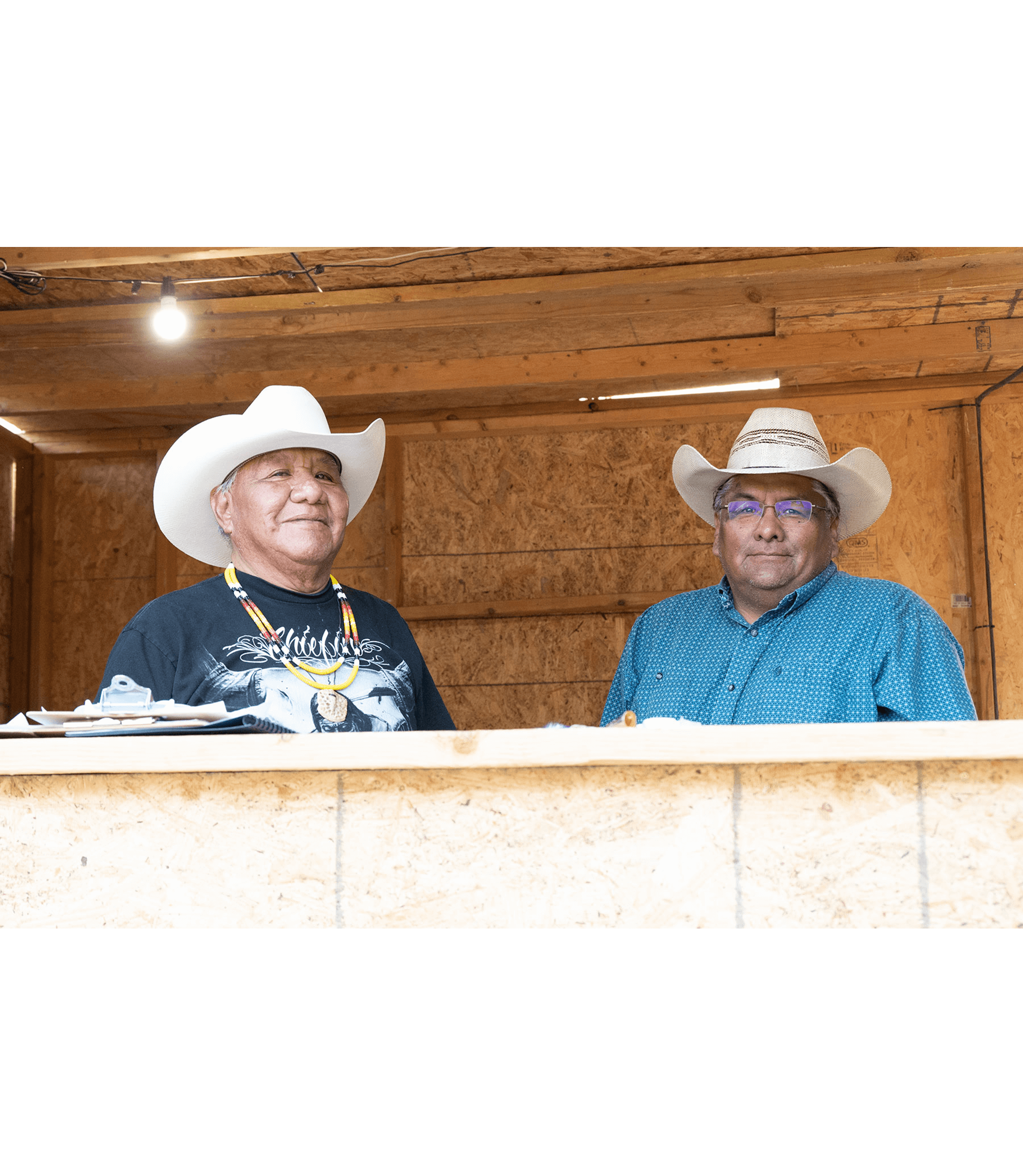 Master of Ceremonies Dano Clark and Bear Dance Chief Mark Wing prepare for the evening’s grand entry of the Ute Mountain Ute Beardance Powwow.
